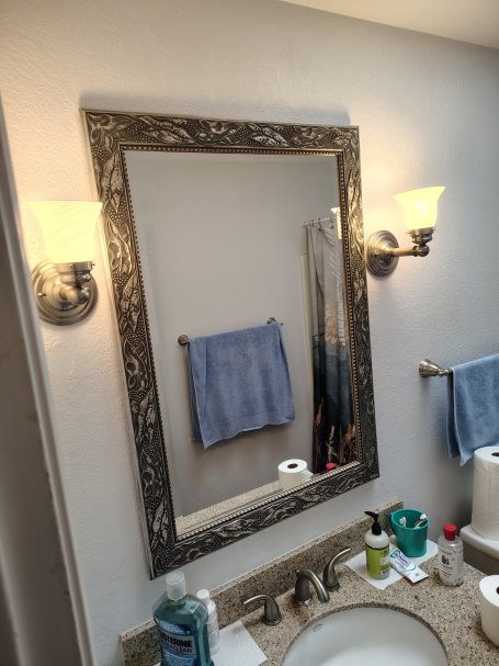 Mirror, wall sconces and towel bar