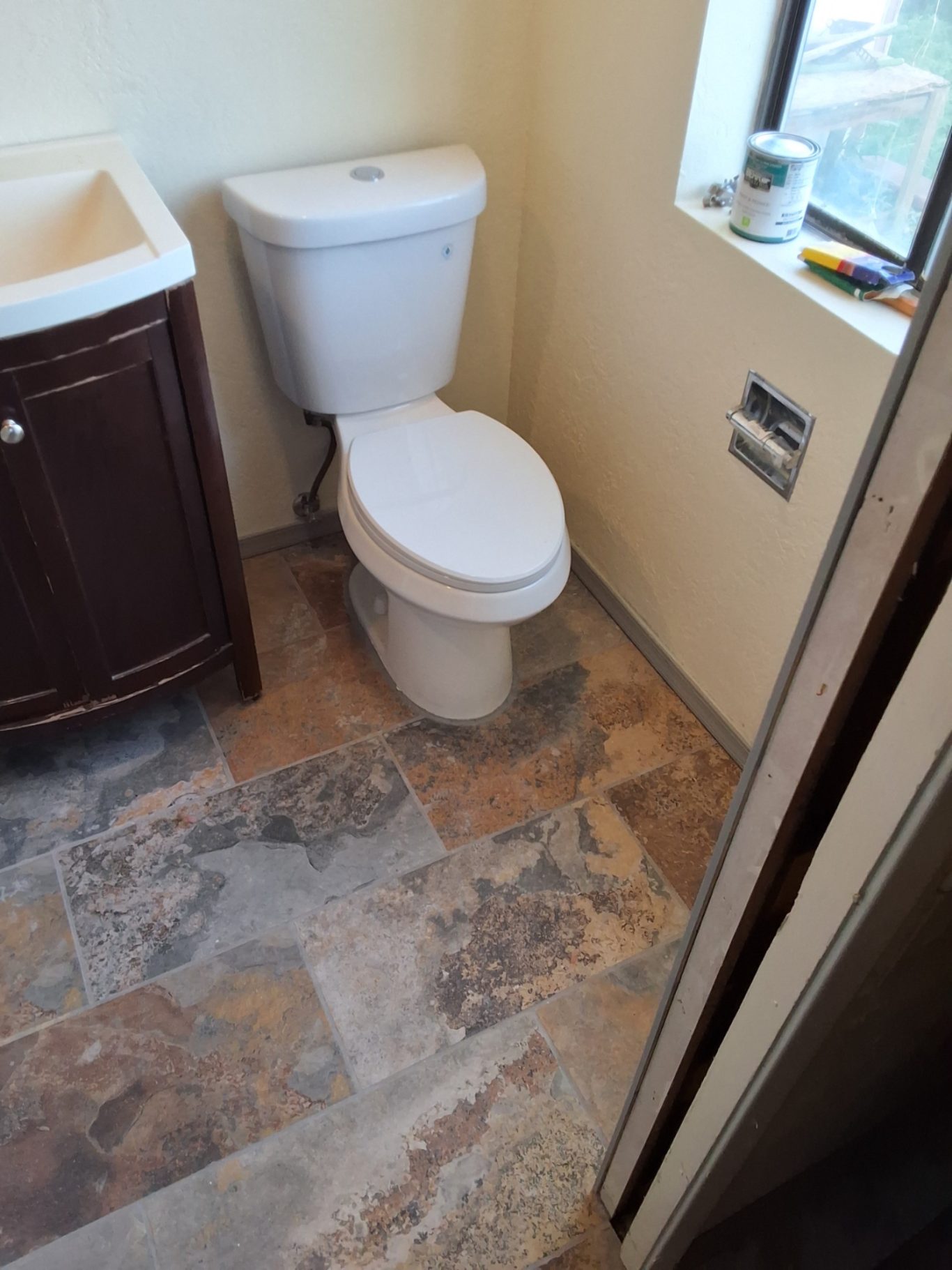 Bathroom remodel with tile flooring new toilet and vanity